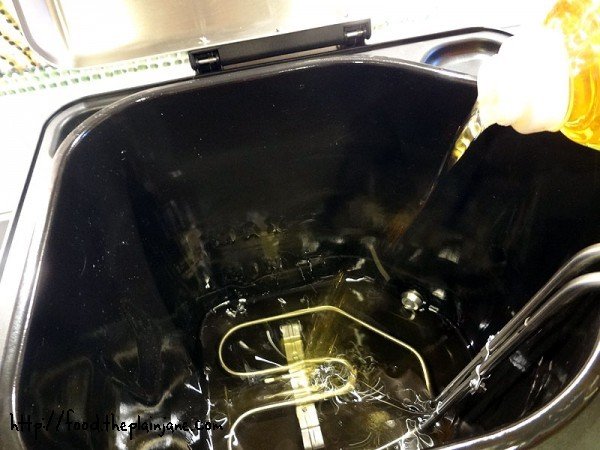filling-up-the-fryer-peanut-oil