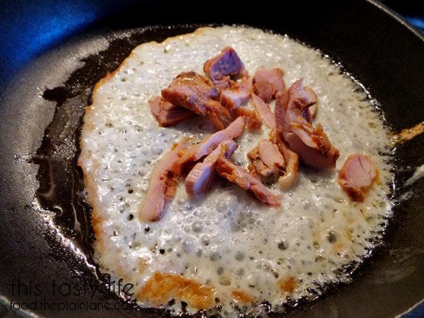 Adding chicken to the melting cheese